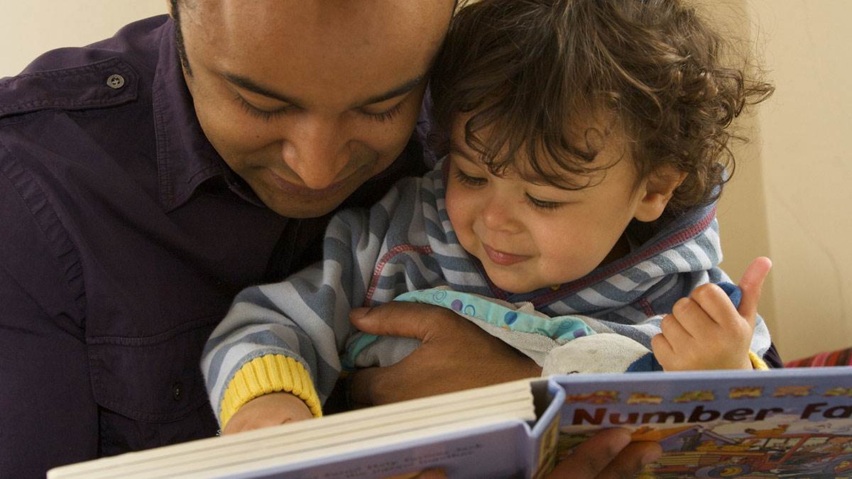 A father and son share a book about numbers