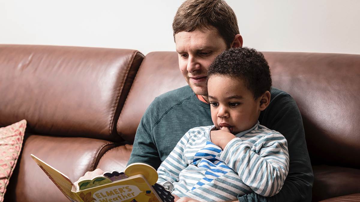 A man reading to a child