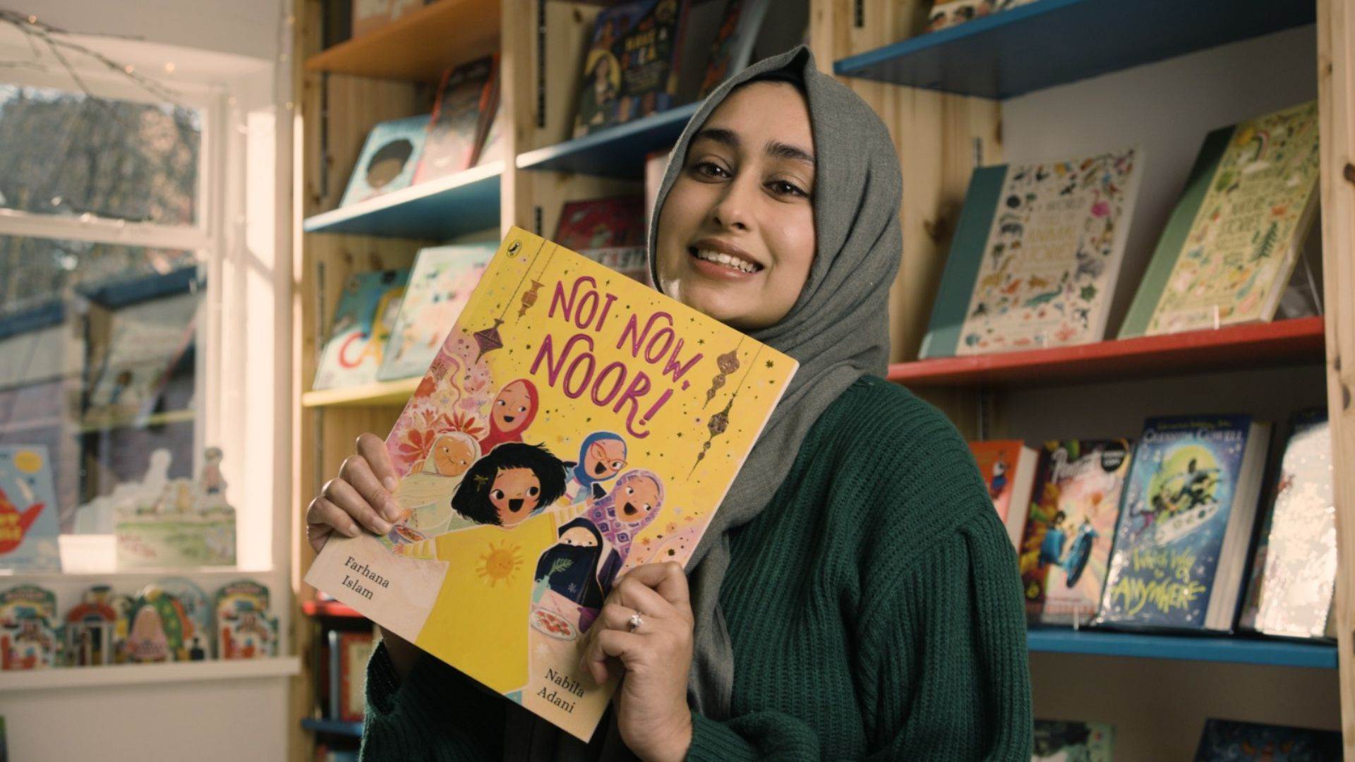 Author Farhana Islam holds a copy of Not Now, Noor!