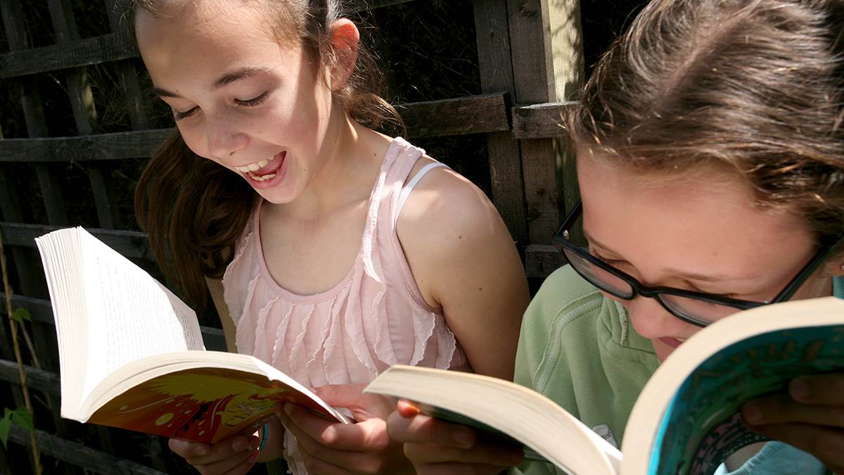 Girls reading in summer