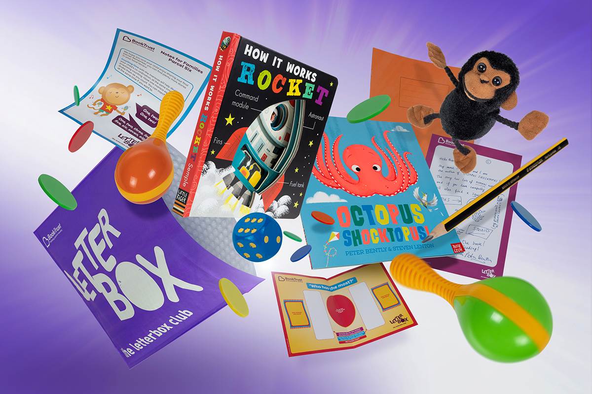 A photo of an example Letterbox Club parcel containing books, a letter, maracas, tokens, activities, dice and a toy monkey