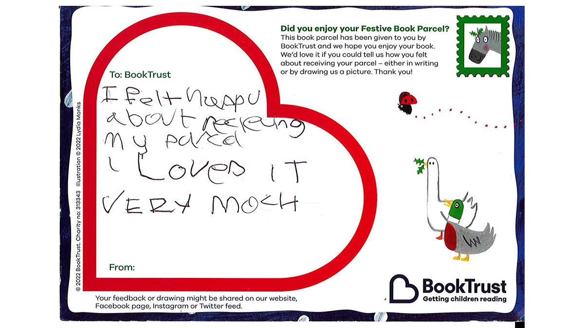 A child's postcard about the festive appeal reading "I felt happy about receiving my parcel, I loved it very much"