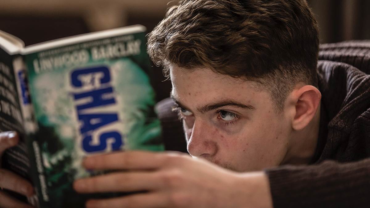 A teenage boy reading
