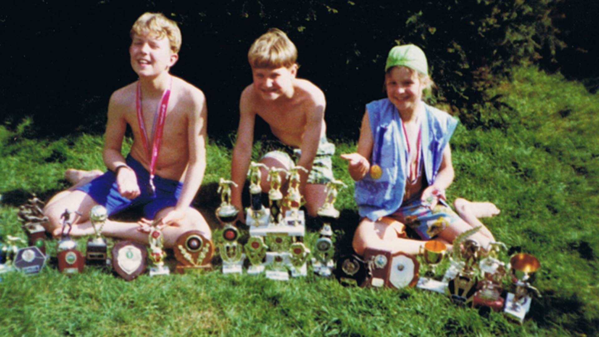 Anna McNuff and her brothers showing off their football trophies as children