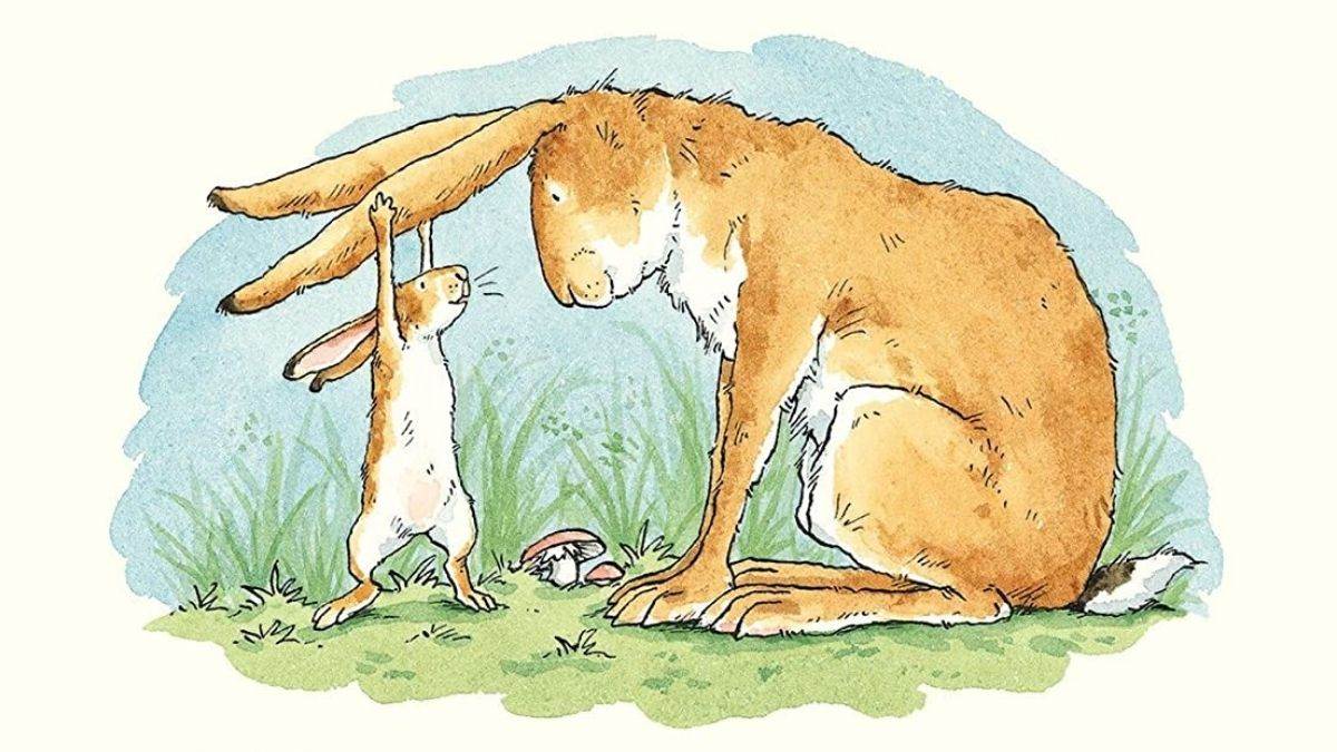 An illustration from the front cover of Guess How Much I Love You - a rabbit leaning over as a young rabbit tugs happily on the adult's ears