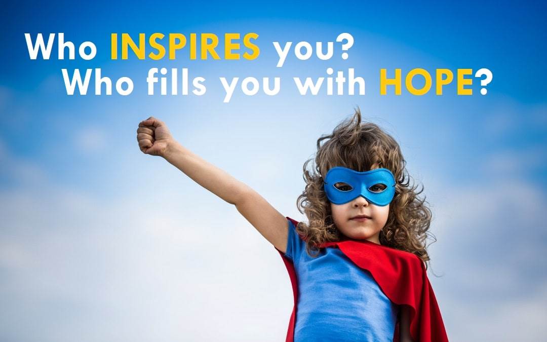 Photo of a child in a superhero costume with their hand in their air and the caption "Who inspires you? Who fills you with hope?"