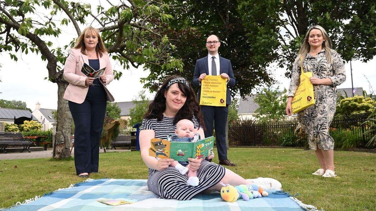 From L-R: Education Minister Michelle McIlveen; mum Judith and baby Eric; Chris Eisenstadt, Director of BookTrust Northern Ireland office; student Health Visitor Laura Gallagher. 