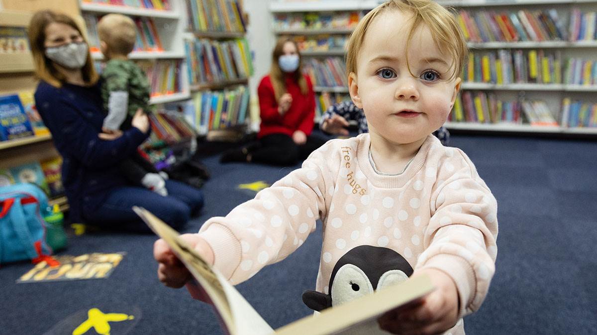 A child enjoying a BookTrust Storytime session at their library
