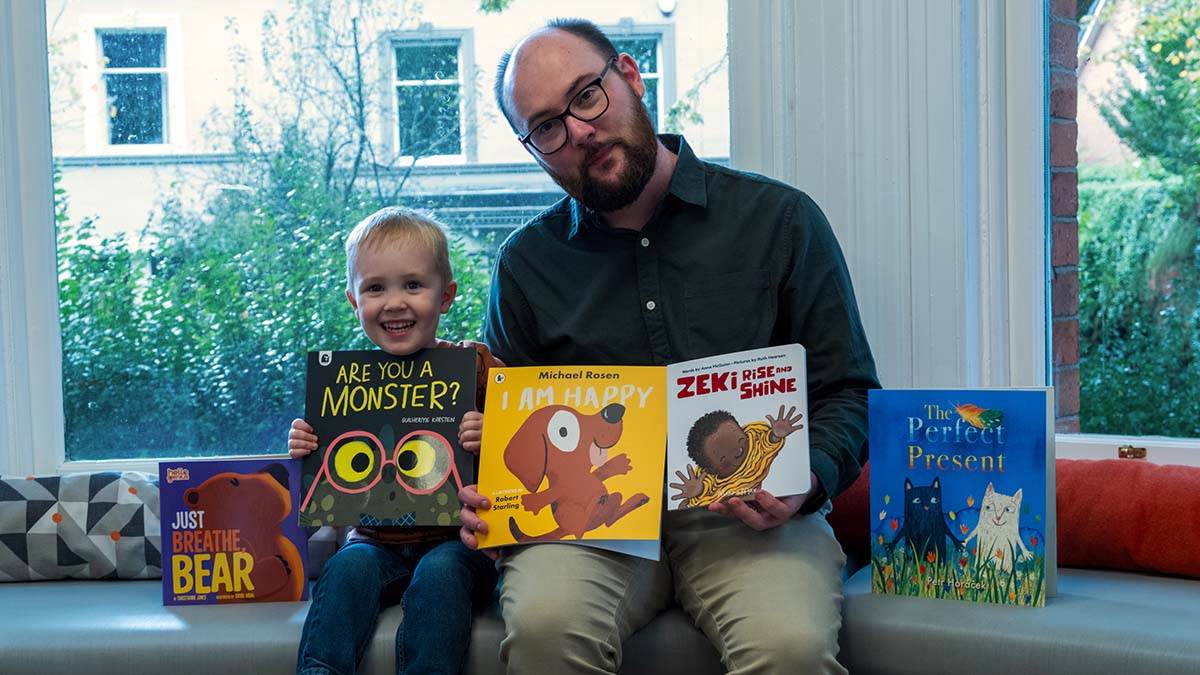 BookTrust NI's Chris Eisenstadt and his son with the BookTrust Storytime books