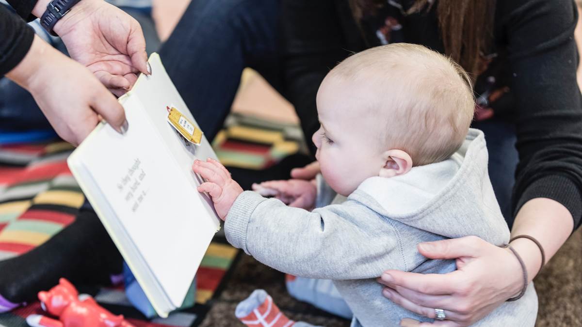 Baby being shown books at a children's centre