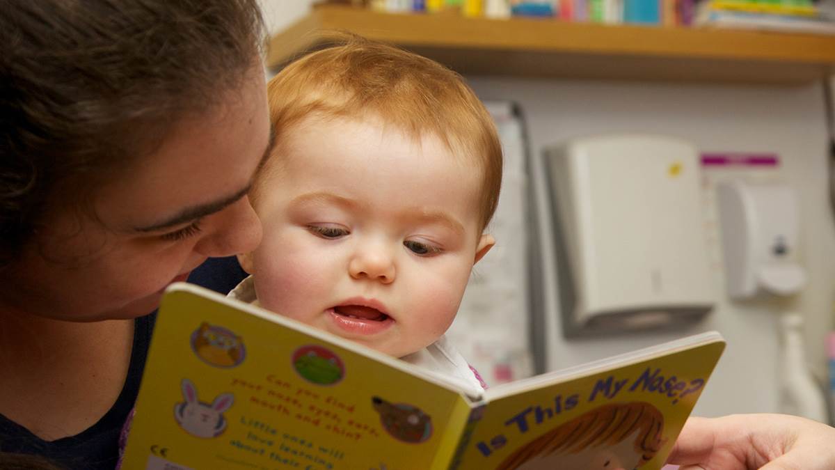 close-up of mum and baby with book