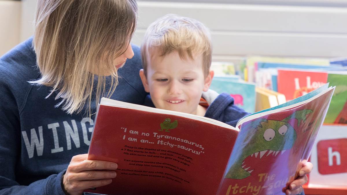Boy and mum reading at the library