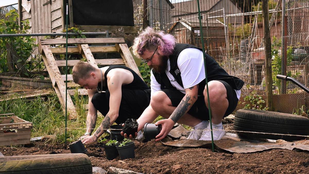Dads Nathan and Louie planting on an allotment together as part of WILD Parents Project