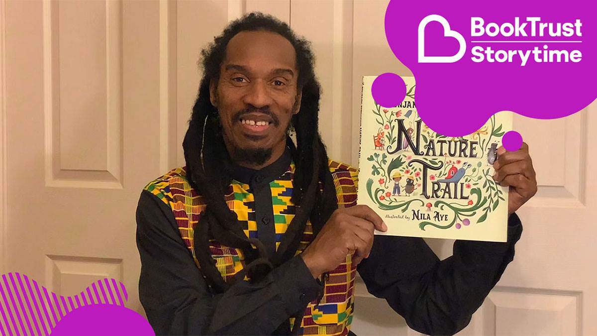 Benjamin Zephaniah smiling with his book Nature Trail